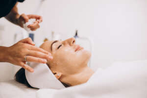 Cosmetologist cleaning face of a woman in a beauty salon cosmetologist cleaning face woman beauty salon